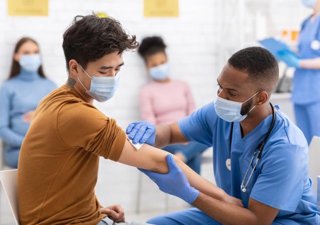 A doctor administering a vaccine to a patient. Image credit: Prostock Studio via Shutterstock