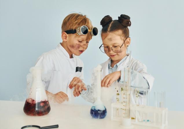Kids dressed as scientists collaborating on a project. Image credit: Standret via Shutterstock
