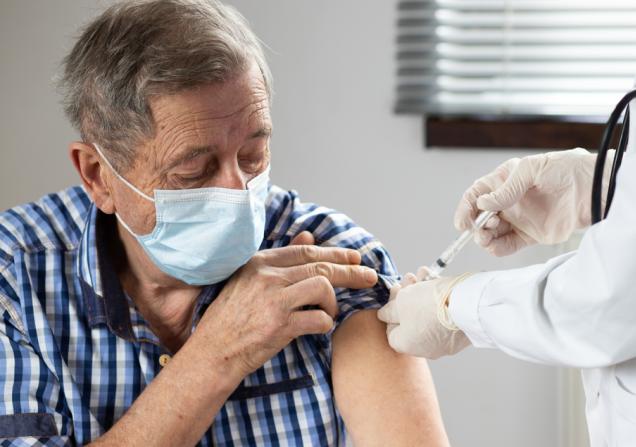 Elderly man getting a vaccine. Image by Melinda Nagy via Shutterstock.
