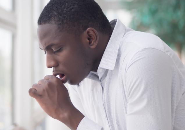 Man with TB coughing. Image by 9NONG via Shutterstock.