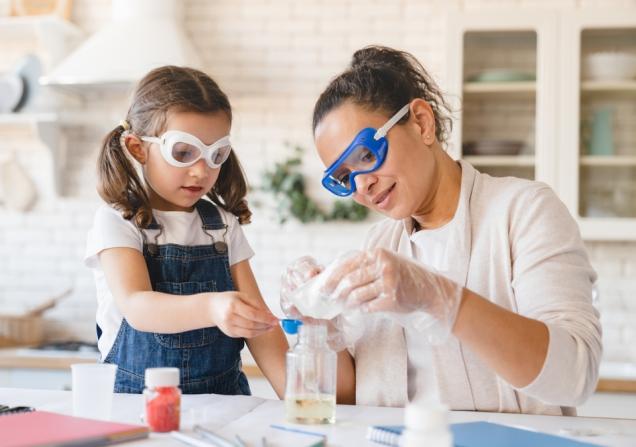 Researcher teaching child about science. Image credit: Inside Creative House via Shutterstock