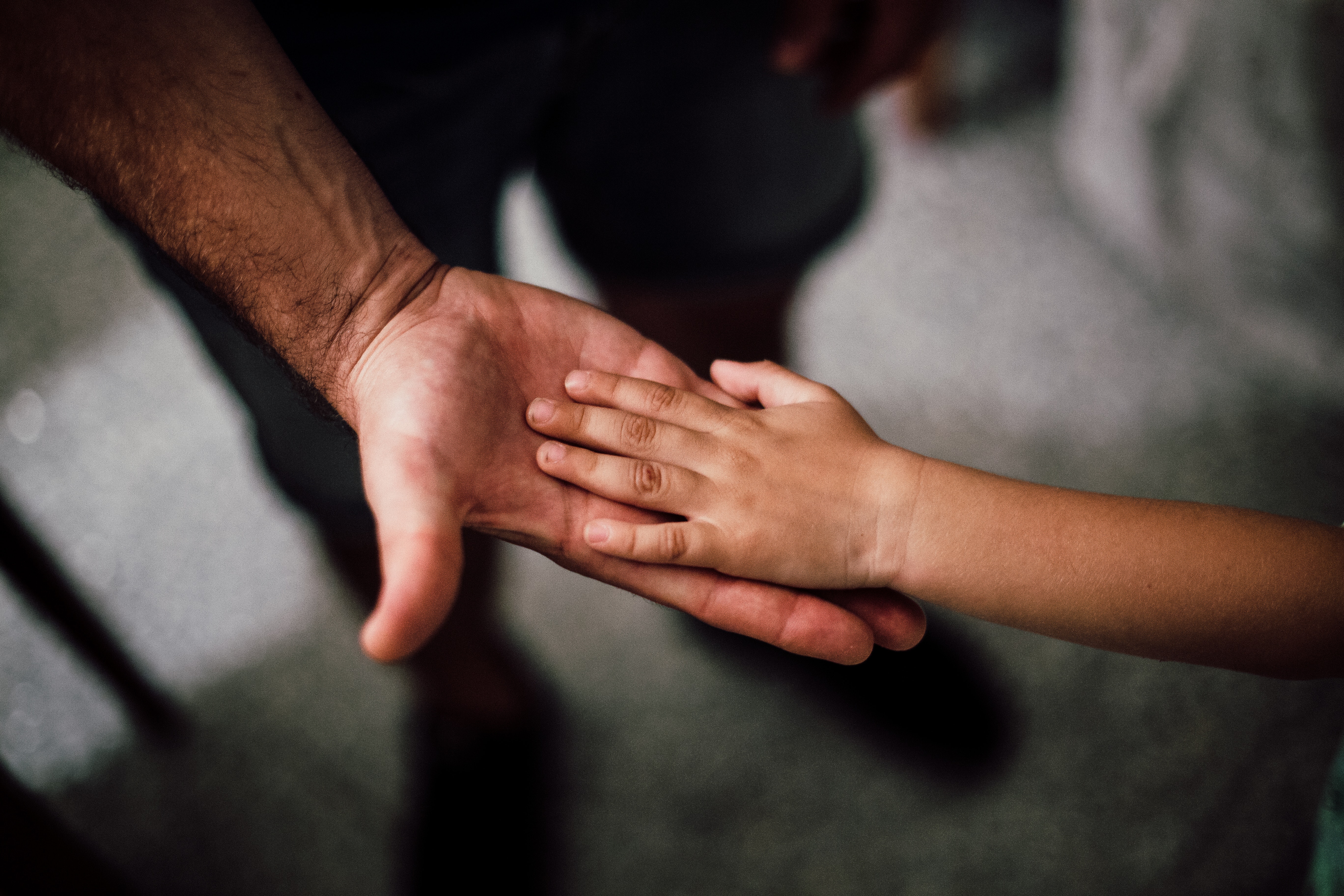 A child's hand in an adult's. Image by Juan Pablo Serrano Arenas via Pexels.