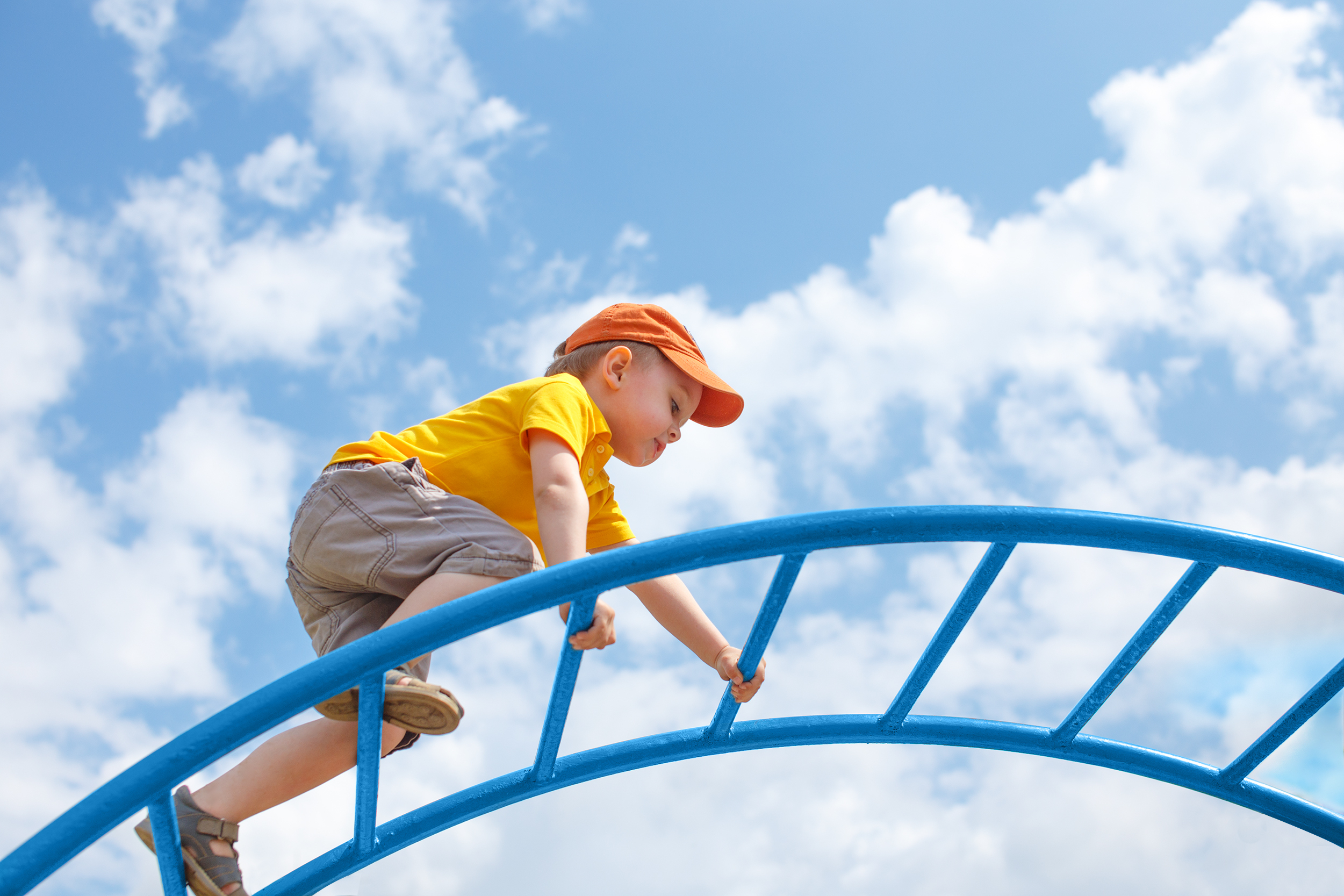 Child climbing on a play frame. Image coutresy of EvgeniiAnd via Shutterstock