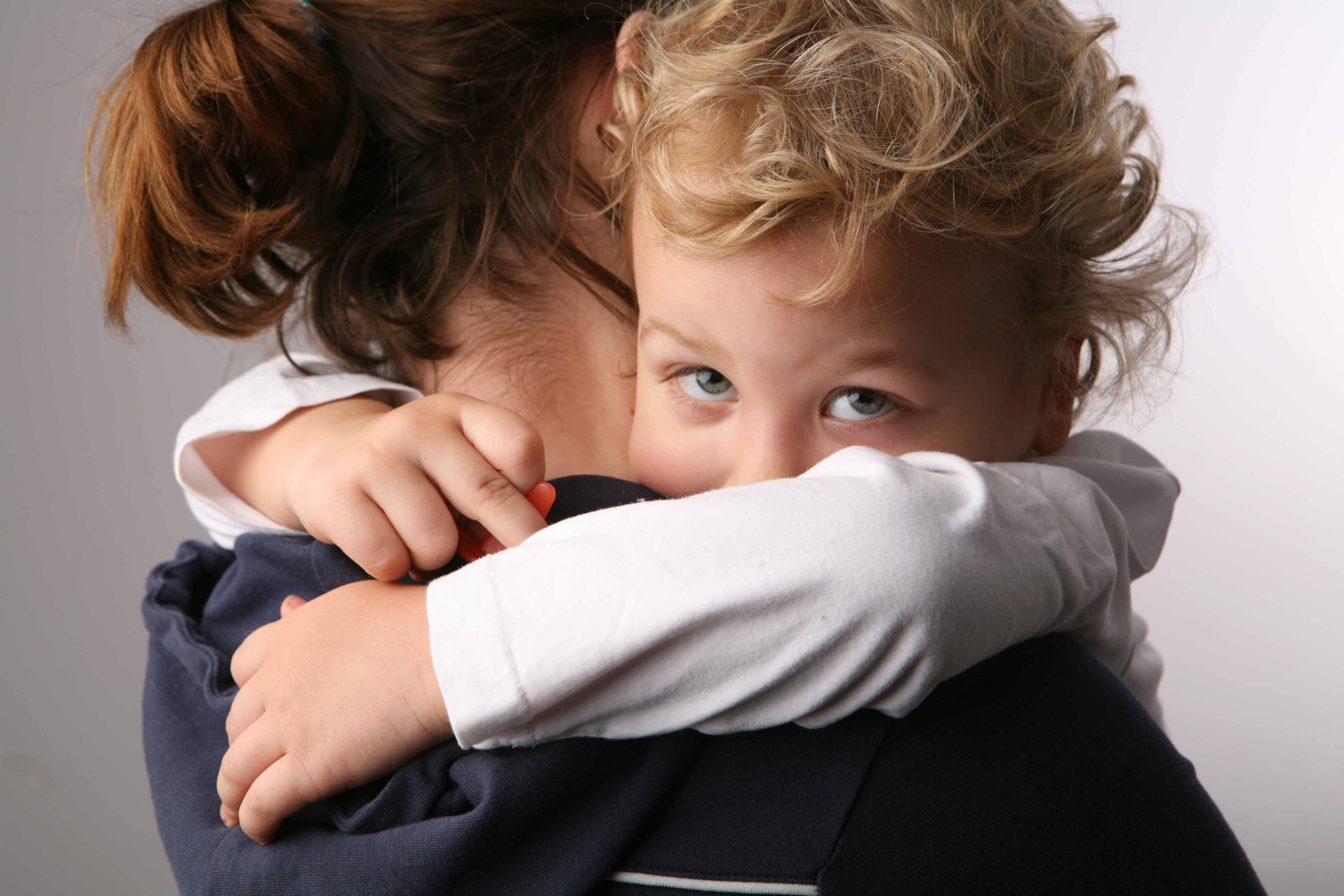 A child embraces his mother. Image courtesy of Boumen Japet va Shutterstock