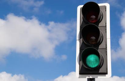 Image by Eddie J. Rodriquez via Shutterstock. A green traffic light against a blue sky with a few fluffy white clouds. Image by Eddie J. Rodriquez via Shutterstock.