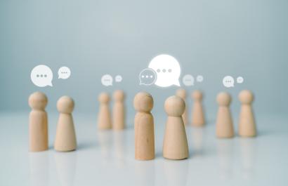 Image by THEBILLJR via Shutterstock. Little wooden figurines talking to each other, representing networking. Image by THEBILLJR via Shutterstock.