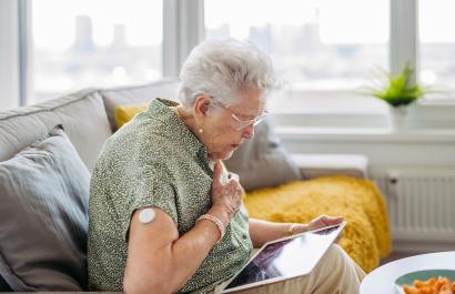 A diabetic woman clutching her heart; cardiac problems are common in diabetes.