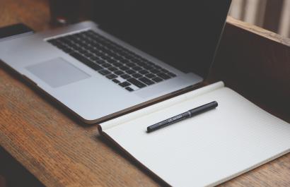 Image by StartupStockPhotos via Pixabay An open laptop and a blank notebook and pen. Image by StartupStockPhotos via Pixabay