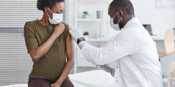 A pregnant woman receiving a vaccine. Image by Seventyfour via Adobe Stock.