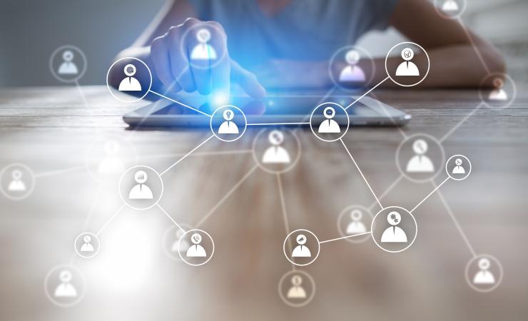 White pictogram of people connecting to a tablet. Image by Wright Studio via Shutterstock.