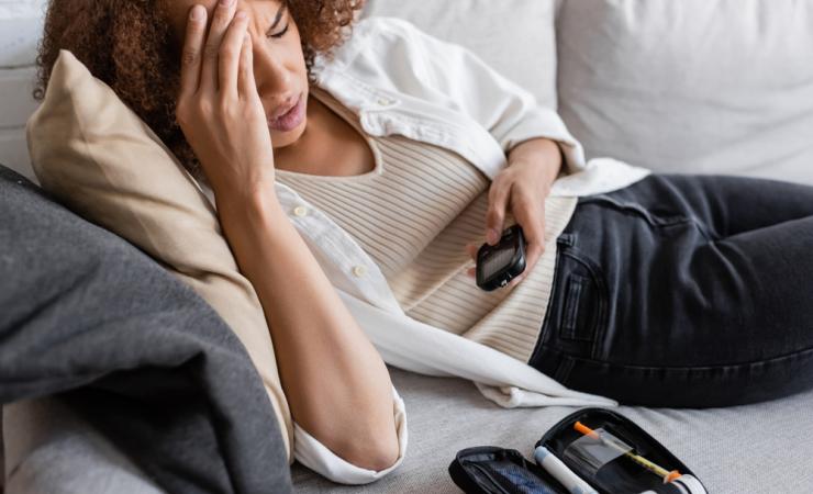 Tired woman with glucometer. Image credit: Light Field Studios via Shutterstock.