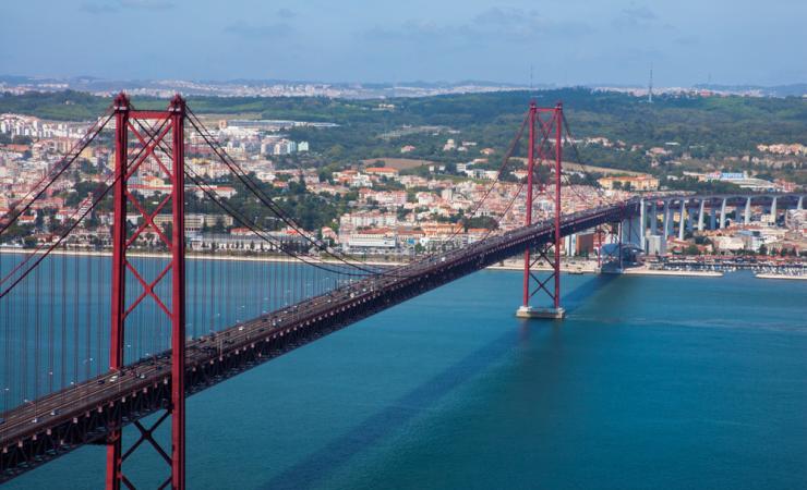 View of the 25 de Abril Bridge and the river in Lisbon. Image by Hivaka via Shutterstock.