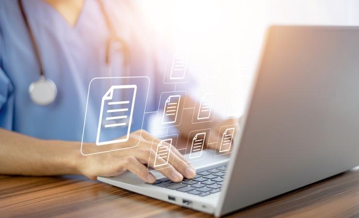 A doctor views treatment guidelines on a computer. Document icons float in the air.