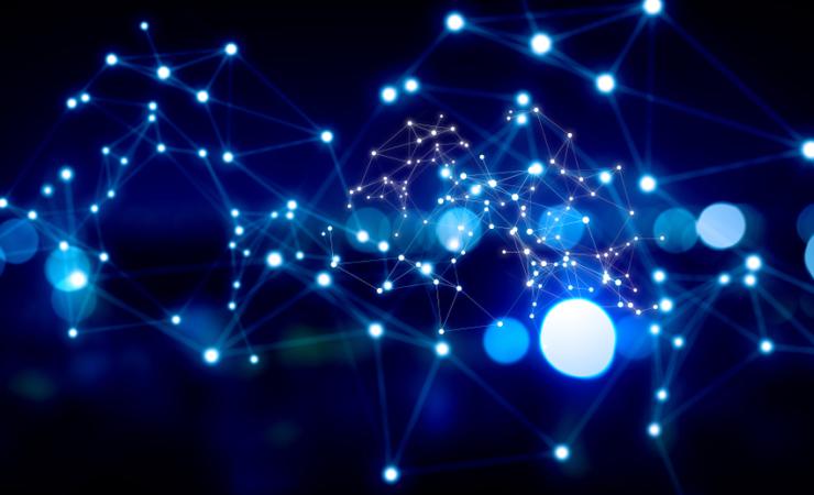 Dots of light linked by thin bright lines against a dark blue background. Image by Sergey Nivens via Shutterstock.