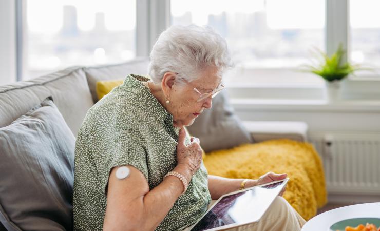 A diabetic woman clutching her heart; cardiac problems are common in diabetes.