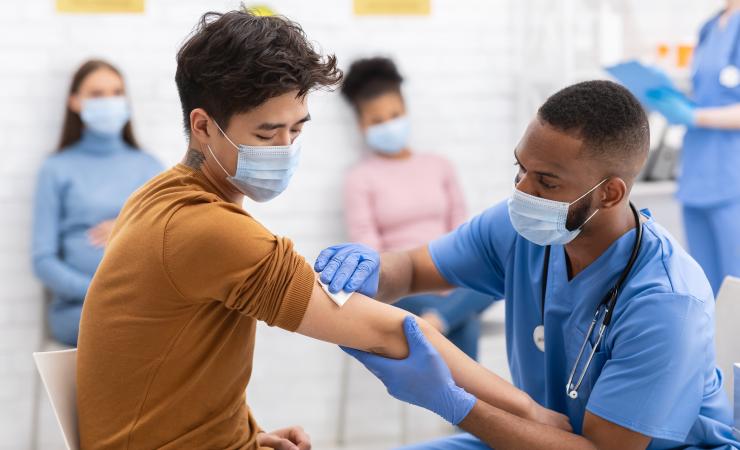 A doctor administering a vaccine to a patient. Image credit: Prostock Studio via Shutterstock