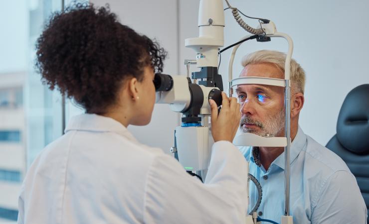 Person undergoing an eye exam. Image credit: People Images - Yuri A via Shutterstock.