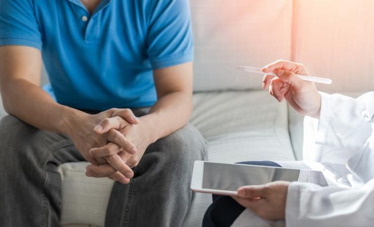 A doctor talking to a man. Bladder and prostate cancer patients need better, more personalised care.