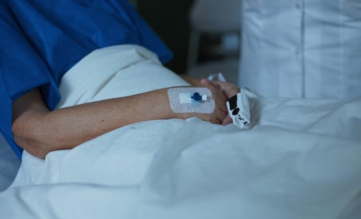 A patient in a bed, getting hospital care at home.
