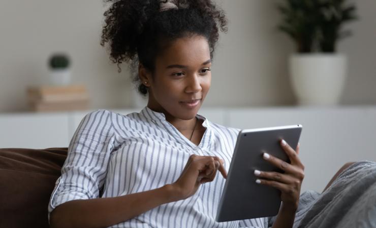 Woman reading tablet. Image credit: fizkes via Shutterstock