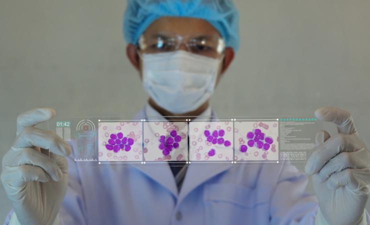 Doctor looking at leukemia cells by T-Photo via Shutterstock
