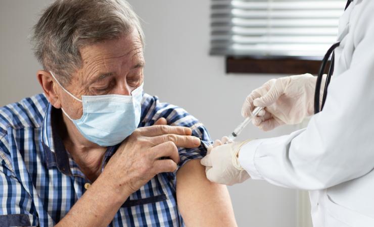 Elderly man getting a vaccine. Image by Melinda Nagy via Shutterstock.