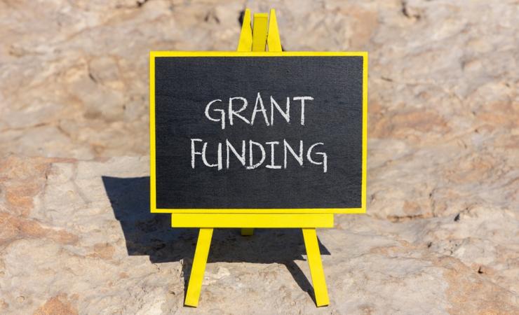 'Grant Funding' written in chalk on a little blackboard. Image by Dmitry Demidovich via Shutterstock.