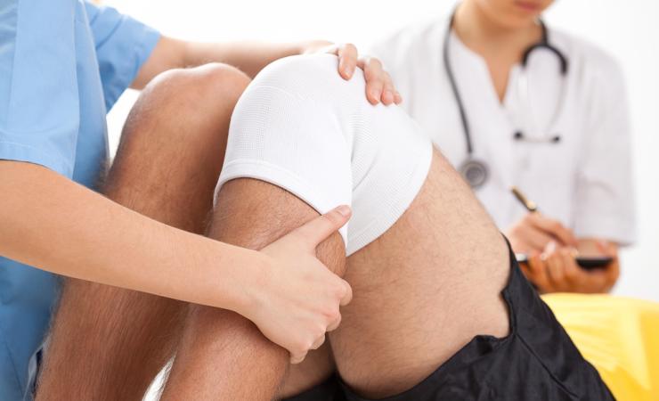 Physio being performed by healthcare worker on prone patient. Image by ESB Professional via shutterstock