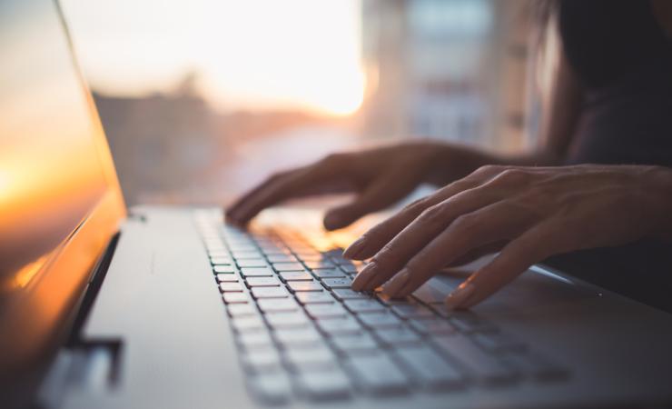 Woman typing. Image by Undrey via Shutterstock