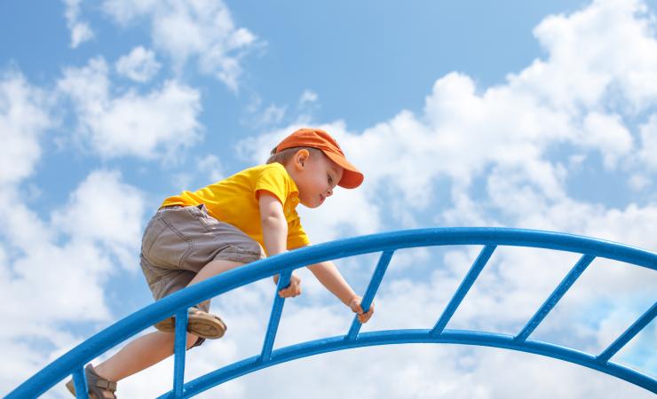 Child climbing by EvgeniiAnd Shutterstock