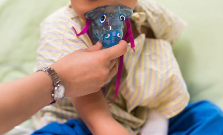 Child using medical mask. Image by Blanscape via Shutterstock