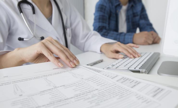 Health worker data entry by Leonardo Da via shutterstock