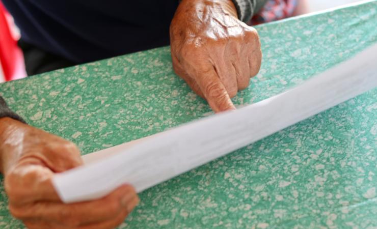 Elderly person reading a medicines leaflet by kikpokemon via Shutterstock