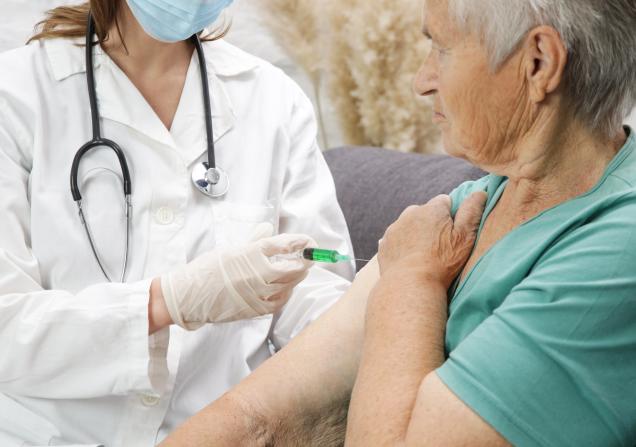 A senior person receiving a vaccine in the arm. Image credit: triocean via AdobeStock.