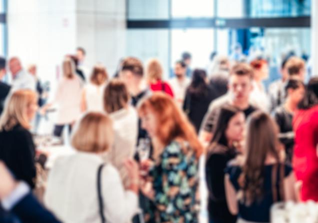 Blurred image of businesspeople at coffee break at conference meeting. Image by Matej Kastelic via Shutterstock.