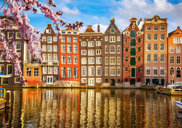 Houses along Amsterdam canal. Image credit: Image sborisov via Adobe Stock.