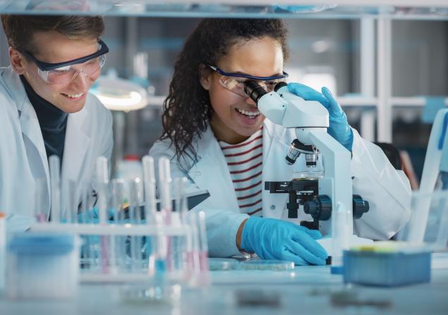 Two young researchers working together in a lab. Image by Gorodenkoff via Shutterstock
