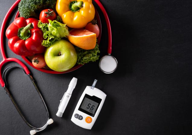 A fruit basket with a diabetes monitor. Image by siam.pikkato via Shutterstock.