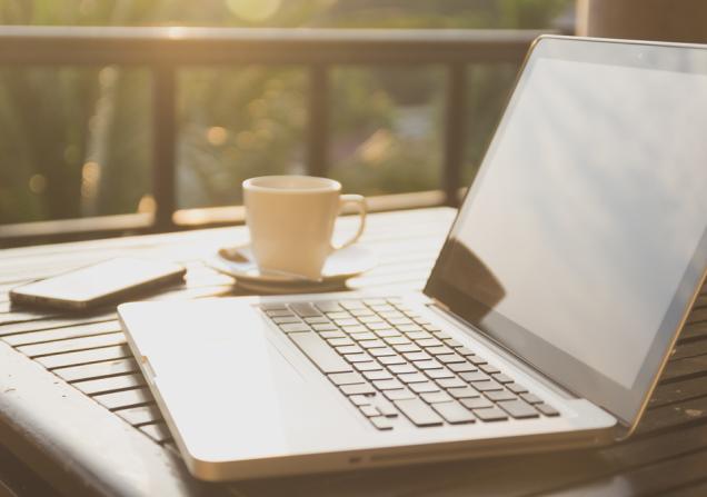 A laptop on a table outdoors. IHI call topics for health research and innovation projects are online. Image: TNShutter, Shutterstock