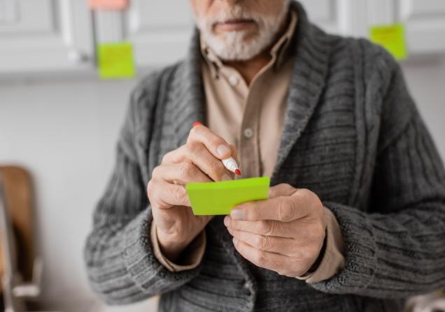 A man with memory problems due to early stage Alzheimer’s disease makes a note. © LightField Studios, Shutterstock