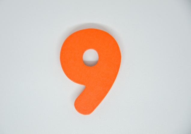 A bright orange number nine on a plain, pale background. Image by Fajar Eka Putra via Shutterstock.