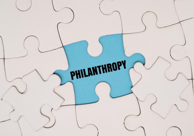 A white jigsaw with a missing piece - the word 'philanthropy' is written in the gap. Image by My Stockers via Shutterstock.