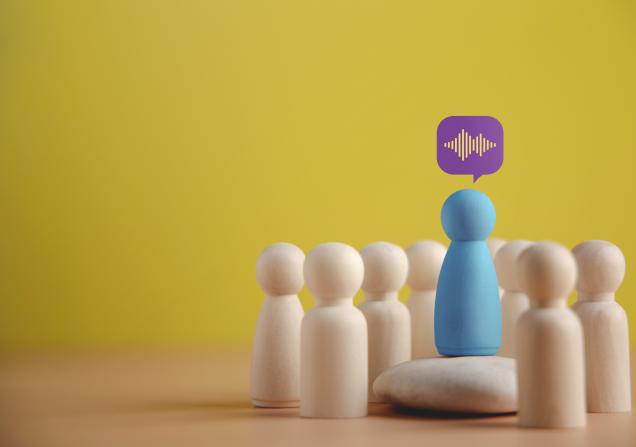 Blue wooden figure giving a speech. Image by BlackSalmon via Shutterstock.