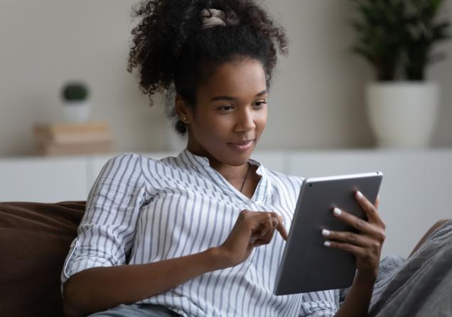 Woman reading tablet. Image credit: fizkes via Shutterstock