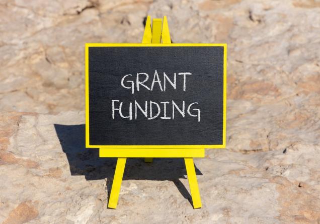 'Grant Funding' written in chalk on a little blackboard. Image by Dmitry Demidovich via Shutterstock.