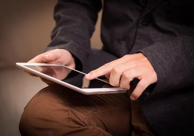 A man using a tablet. Image by Niek Verlaan via Pixabay.
