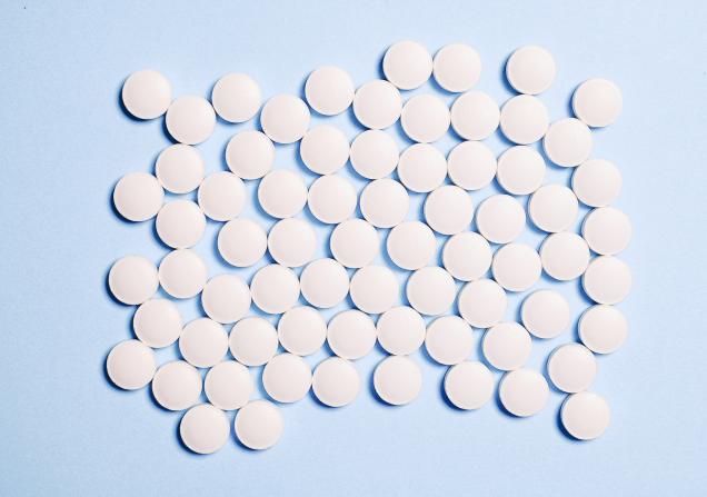 Round white pills on a pale blue background. Image by Anna Shvets via Pexels.