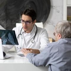 A doctor discussing an arthritis diagnosis with a patient. Image by Vitaliy Abbasov via Shutterstock.