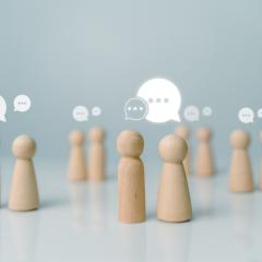 Image by THEBILLJR via Shutterstock. Little wooden figurines talking to each other, representing networking. Image by THEBILLJR via Shutterstock.