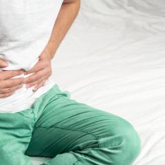 Image by Zdan Ivan via Shutterstock. A person clutching their tummy in pain. Image by Zdan Ivan via Shutterstock.